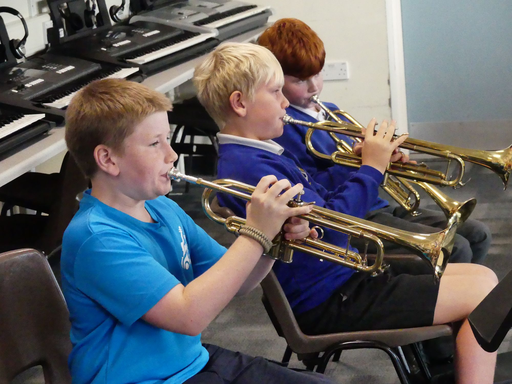 Boys practising on their trumpets